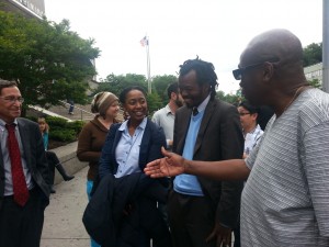 Discussing stop-and-frisk outside Queens Criminal Court. Attorney Steve Silverblatt; defendant Ribka Getachew, and attorney Mani Taferi speaking with juror.